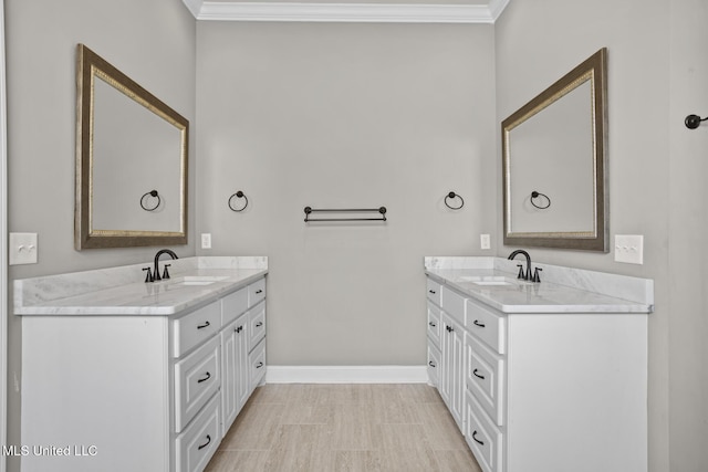 full bathroom featuring crown molding, two vanities, and a sink