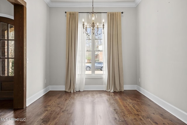 unfurnished dining area featuring dark wood finished floors, a notable chandelier, and baseboards