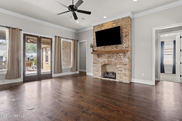 unfurnished living room with a fireplace, wood finished floors, a ceiling fan, and ornamental molding