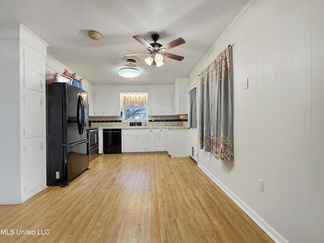 kitchen with light wood-type flooring, tasteful backsplash, ceiling fan, black appliances, and white cabinets