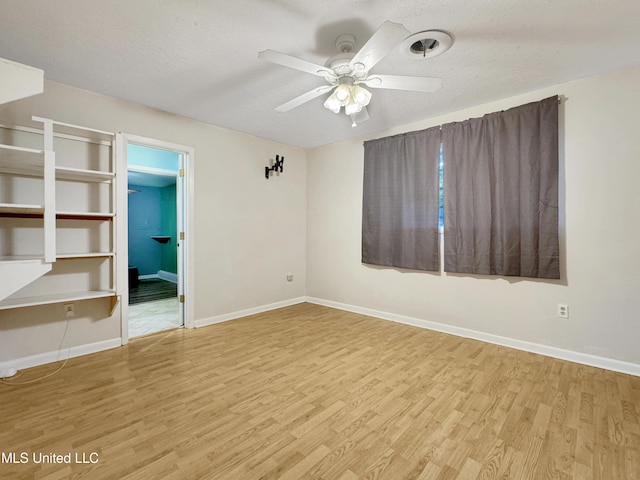 unfurnished bedroom with ceiling fan, a textured ceiling, and light wood-type flooring