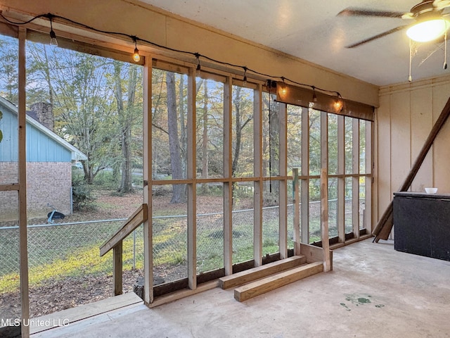 unfurnished sunroom with ceiling fan and a wealth of natural light