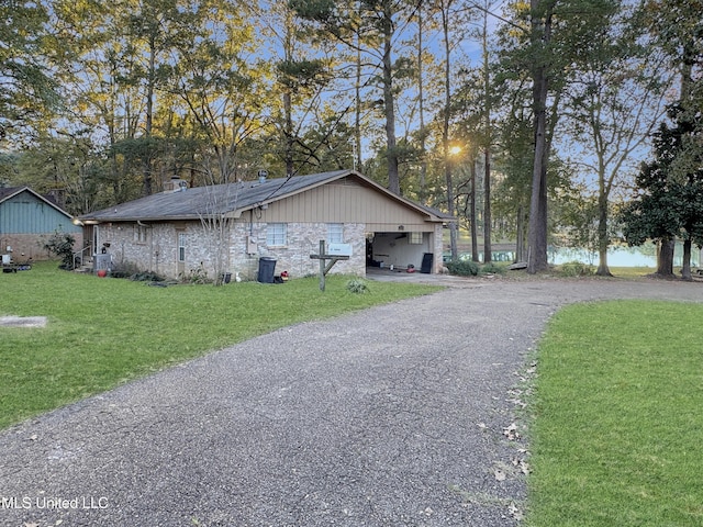 view of side of home featuring a lawn