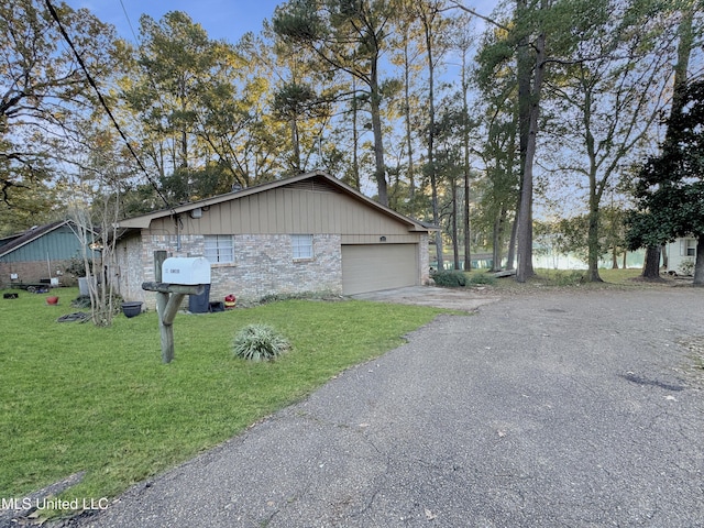 view of side of property with a garage and a lawn