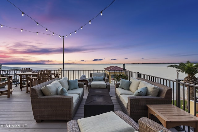 wooden deck featuring an outdoor hangout area and a water view