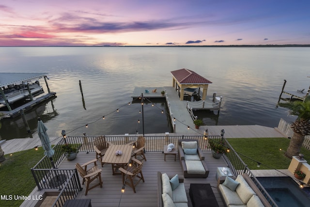 dock with a water view, boat lift, and outdoor lounge area