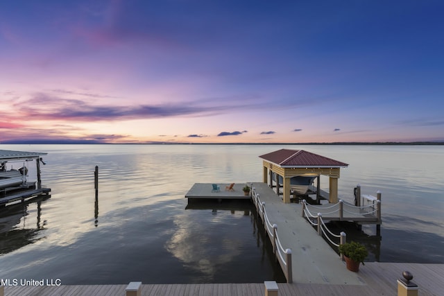 dock featuring boat lift and a water view
