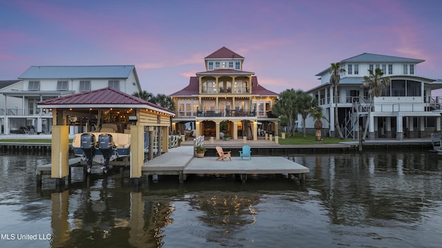 dock featuring a water view, a balcony, and stairs
