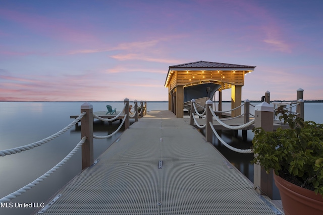 dock with boat lift and a water view