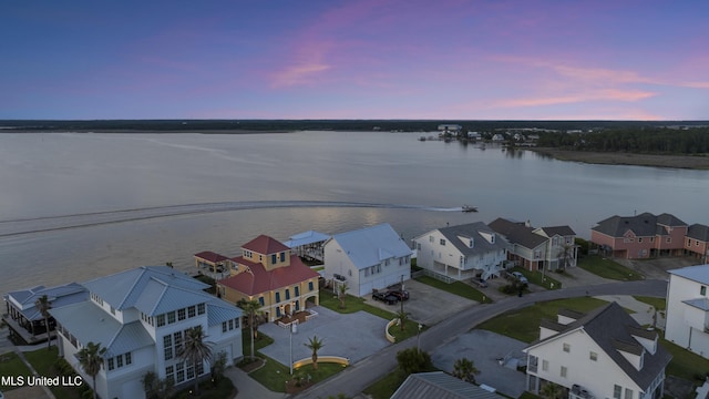 aerial perspective of suburban area featuring a nearby body of water