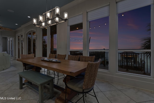 tiled dining space featuring a chandelier