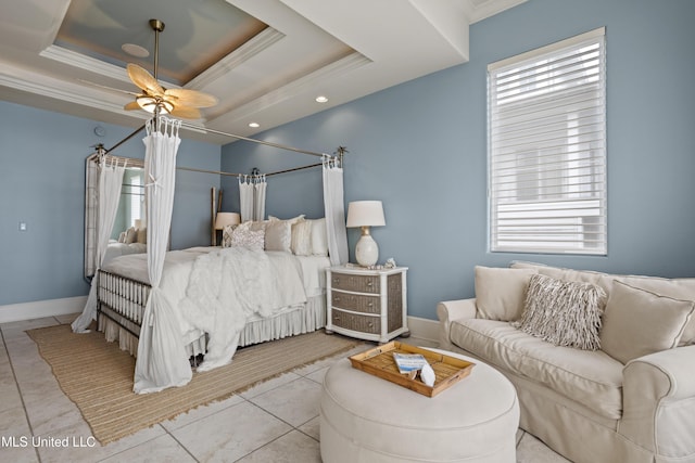 bedroom featuring multiple windows, ornamental molding, a tray ceiling, baseboards, and ceiling fan