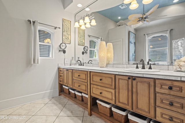 full bathroom featuring tile patterned floors, double vanity, ceiling fan, and baseboards