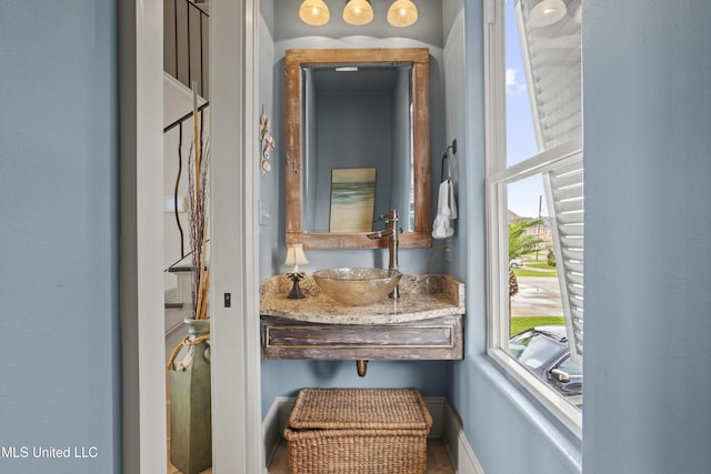 bathroom view of a sink and baseboards