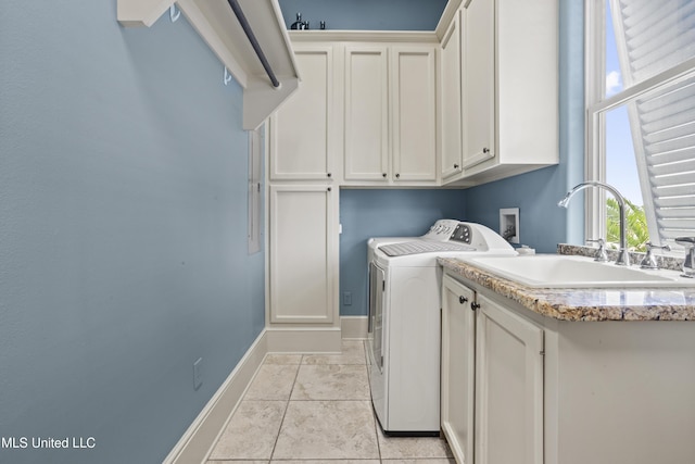 washroom with independent washer and dryer, cabinet space, light tile patterned flooring, and baseboards