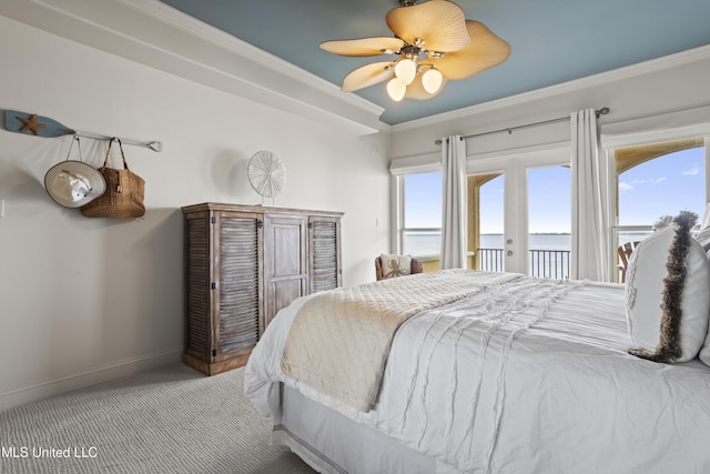 bedroom with access to exterior, carpet floors, a water view, ornamental molding, and baseboards