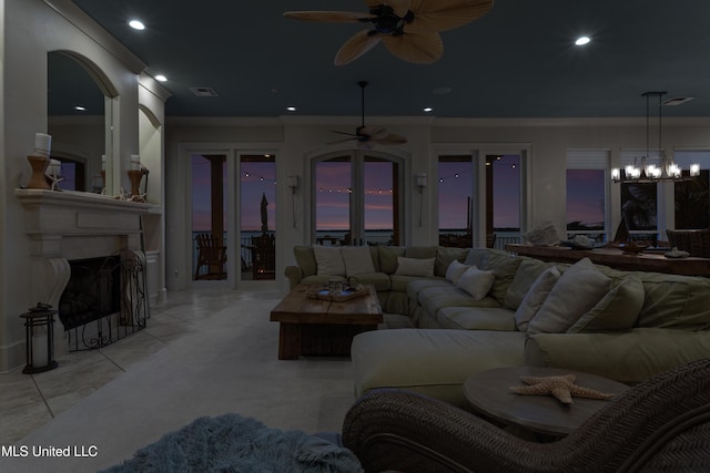 living room featuring ceiling fan, ornamental molding, a fireplace with flush hearth, and recessed lighting