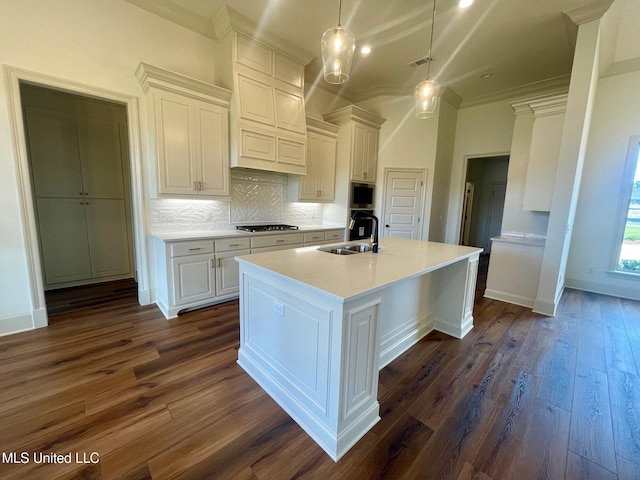 kitchen with dark hardwood / wood-style floors, white cabinetry, stainless steel microwave, and sink