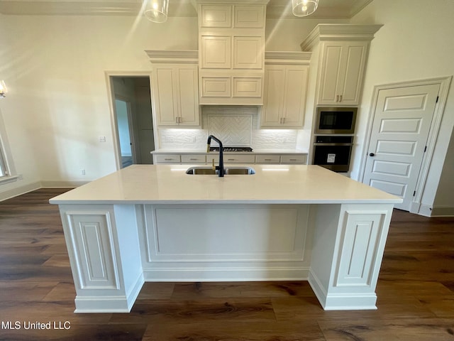 kitchen featuring a large island, sink, oven, and dark wood-type flooring