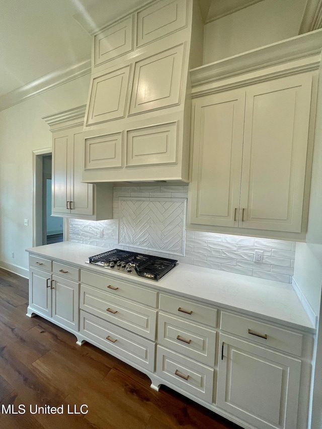 kitchen featuring tasteful backsplash, premium range hood, stainless steel gas stovetop, and dark wood-type flooring