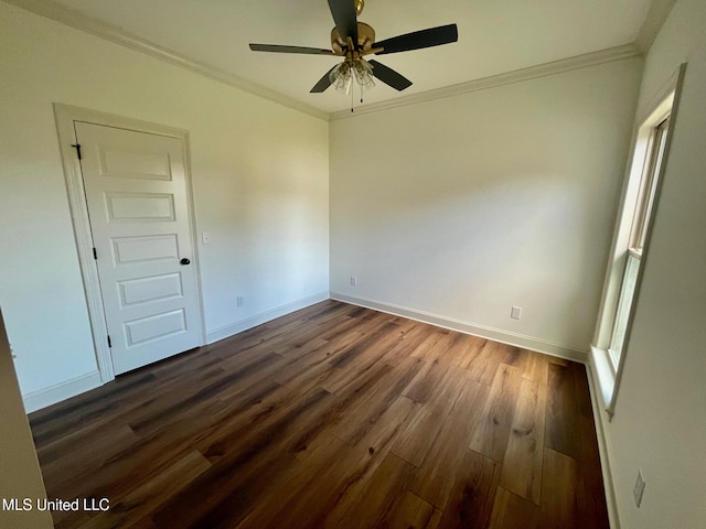 spare room with dark hardwood / wood-style floors, ceiling fan, and crown molding