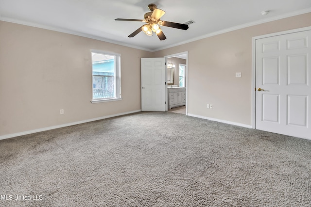 interior space with a wealth of natural light, ornamental molding, and ceiling fan