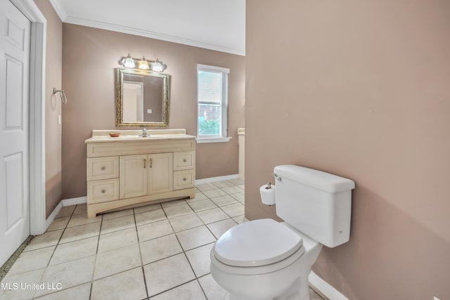 bathroom with vanity, toilet, crown molding, and tile patterned flooring