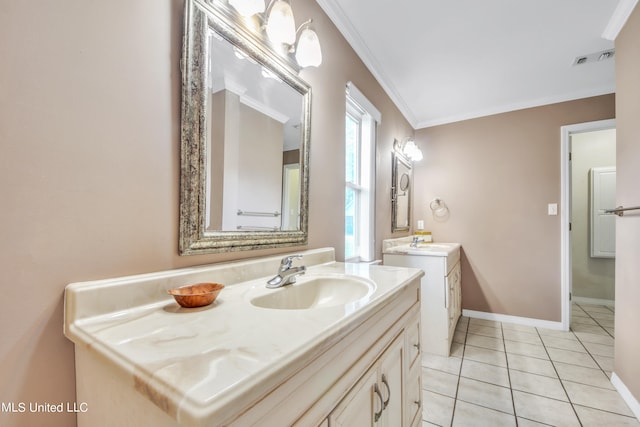 bathroom featuring crown molding, visible vents, a sink, and tile patterned floors