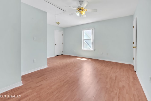 spare room with light wood-type flooring and ceiling fan