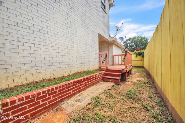 view of yard featuring a wooden deck and fence