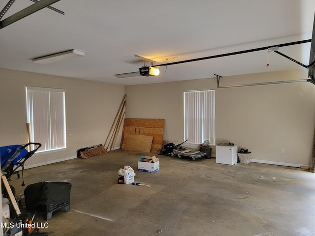 garage featuring a garage door opener and baseboards