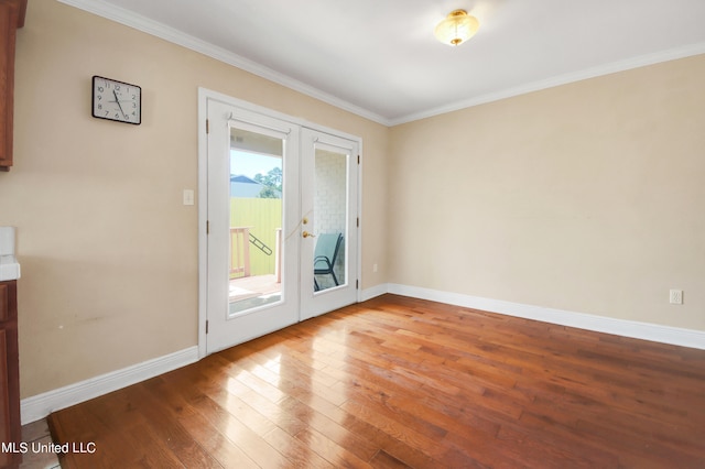 doorway featuring french doors, hardwood / wood-style flooring, and crown molding