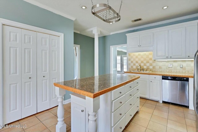 kitchen featuring tasteful backsplash, visible vents, white cabinets, a sink, and dishwasher