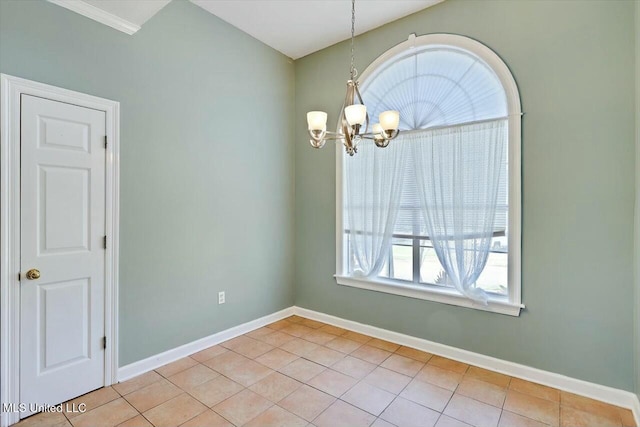 unfurnished room featuring a chandelier, light tile patterned floors, and baseboards