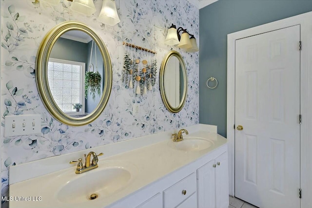 bathroom with double vanity, a sink, and wallpapered walls