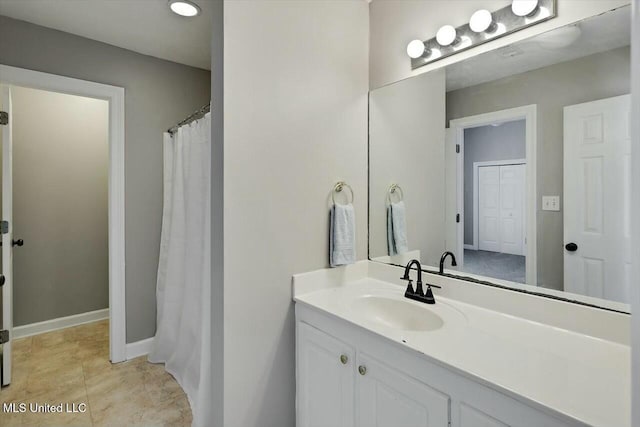 bathroom featuring baseboards and vanity