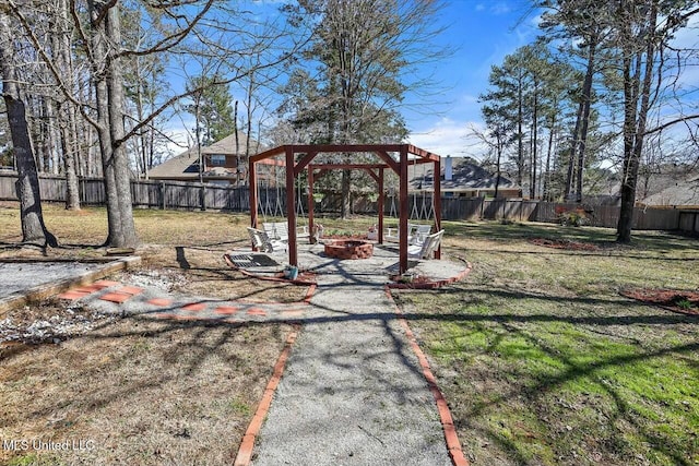 view of yard with a fire pit and a fenced backyard