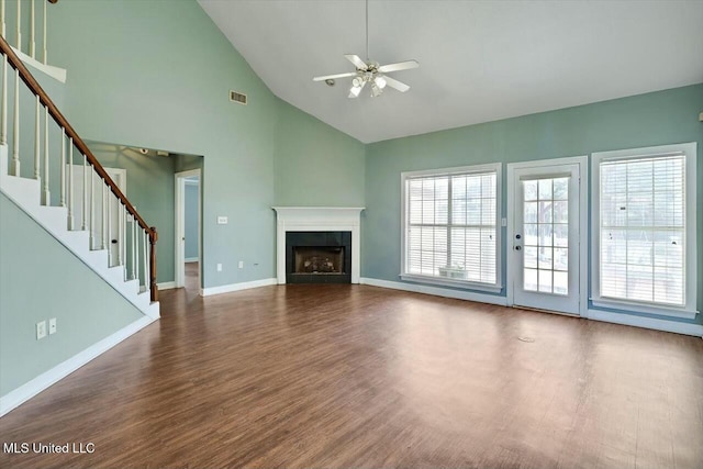 unfurnished living room with dark wood-style floors, a fireplace, visible vents, baseboards, and stairs