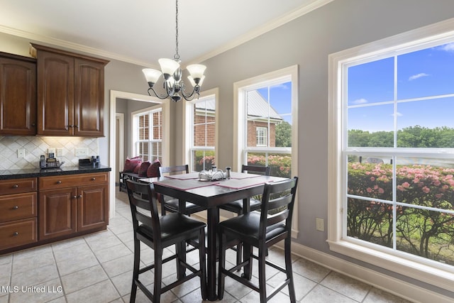 1600 Wright Rd, Raymond, MS 39154 - dining space featuring crown molding, a chandelier, light tile patterned flooring, and baseboards