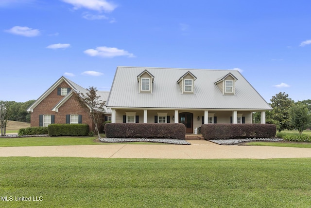1600 Wright Rd, Raymond, MS 39154 - cape cod-style house with a front lawn, covered porch, and metal roof