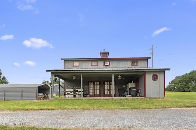1600 Wright Rd, Raymond, MS 39154 - view of front facade featuring a front yard, french doors, a carport, and a chimney