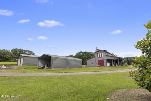 1600 Wright Rd, Raymond, MS 39154 - view of green lawn featuring an outbuilding, a detached carport, dirt driveway, and a barn