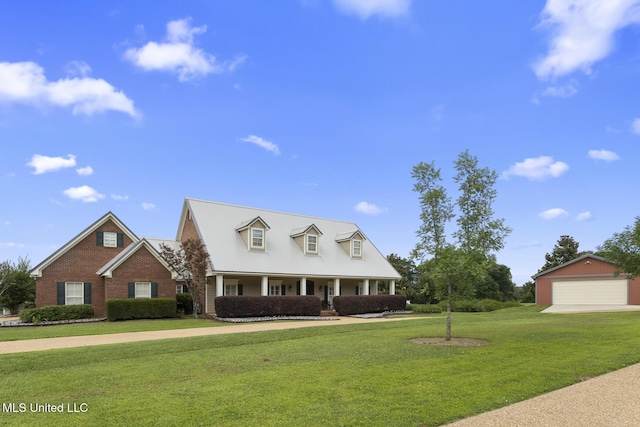 1600 Wright Rd, Raymond, MS 39154 - cape cod-style house with a front lawn, a porch, brick siding, an outdoor structure, and a detached garage