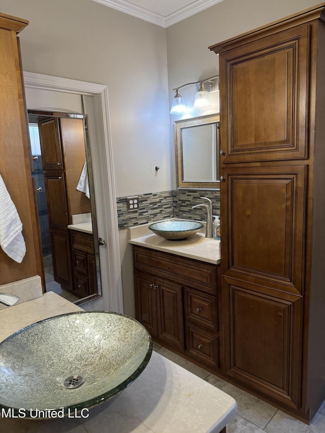 bathroom with ornamental molding, tile patterned flooring, vanity, and decorative backsplash