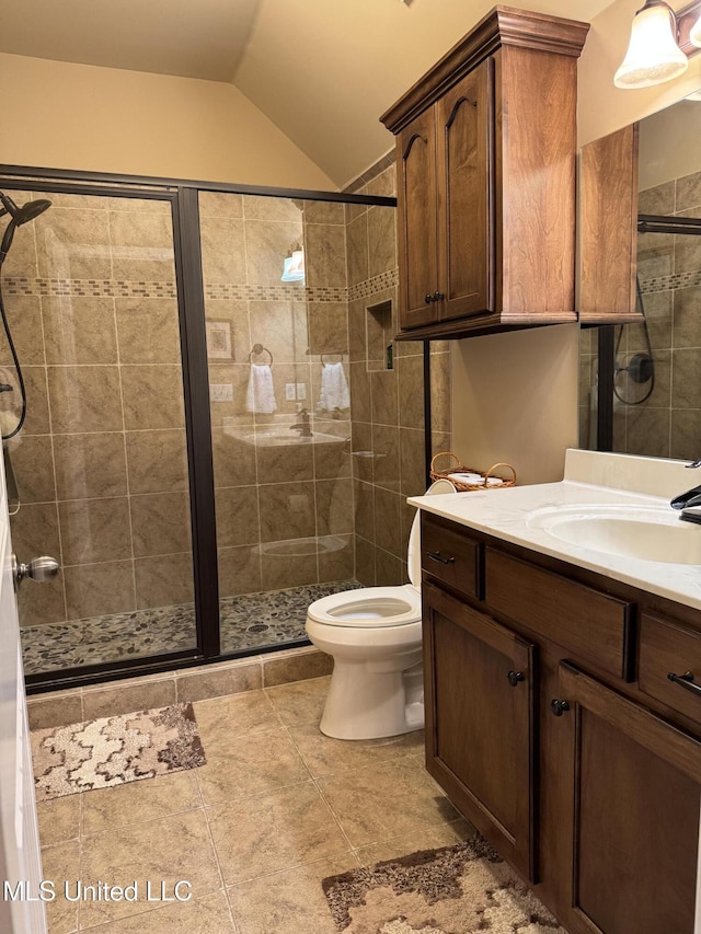 full bathroom featuring toilet, a stall shower, vaulted ceiling, and vanity