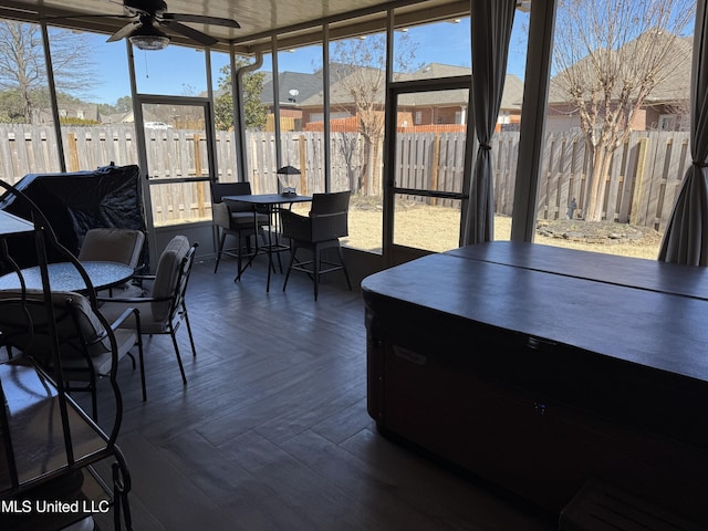 sunroom featuring ceiling fan