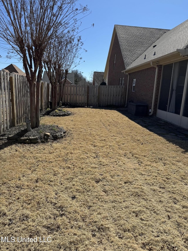 view of yard with a fenced backyard