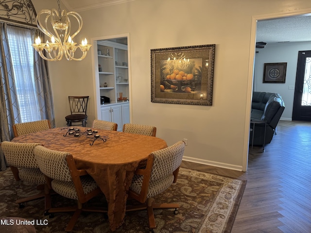 dining room with a wealth of natural light, baseboards, and a notable chandelier