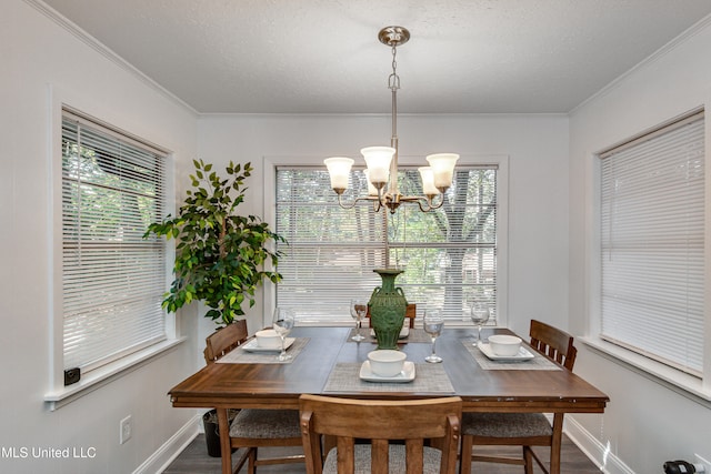 dining room featuring a notable chandelier, dark hardwood / wood-style floors, ornamental molding, and a textured ceiling