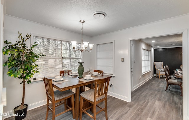 dining space featuring a textured ceiling, crown molding, and dark hardwood / wood-style floors